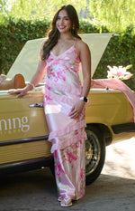Full length front view of a pink floral print maxi dress with tiered ruffles and a V-neckline