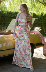 Yellow floral satin maxi dress with a cowl neck, spaghetti straps, and a ruched side detail