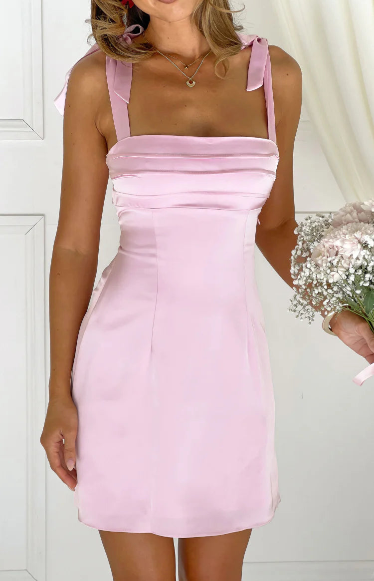 Pink satin mini dress with tie shoulder straps and a gathered square neckline