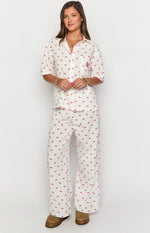 Front view of a white short sleeve collared pajama shirt with red cherry print, chest pocket, and BB logo