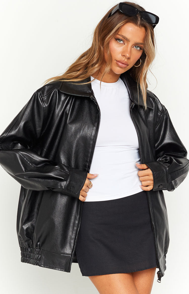 Black PU bomber jacket with an oversized fit, open zipper front, collared neckline, and elasticated hem