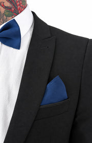 Close-up of a navy bow tie and matching navy pocket square in a black suit jacket