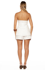 Rear view of a white strapless longline top with floral embroidery and a relaxed fit