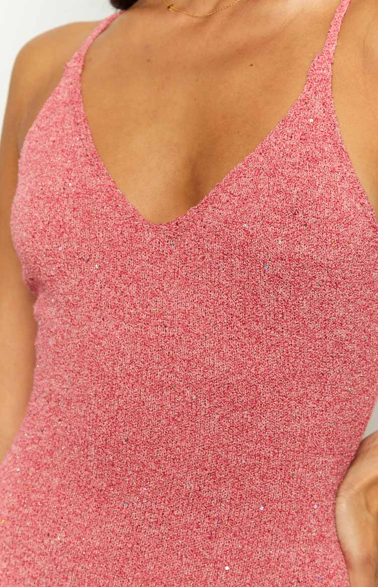 Close-up of the pink knit V-neckline and spaghetti strap of a maxi dress with subtle shimmer detail