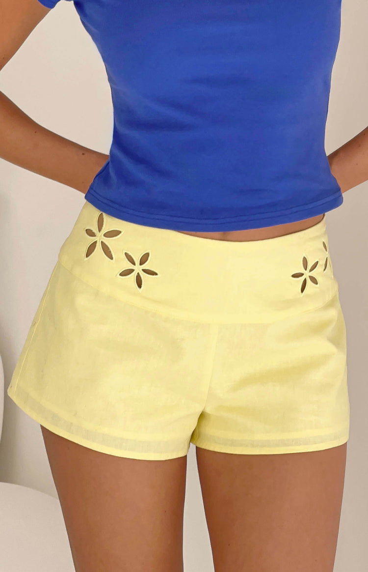Beginning Boutique Alamara Yellow Floral Detail Shorts yellow high-waisted shorts with floral cutouts on the waistband