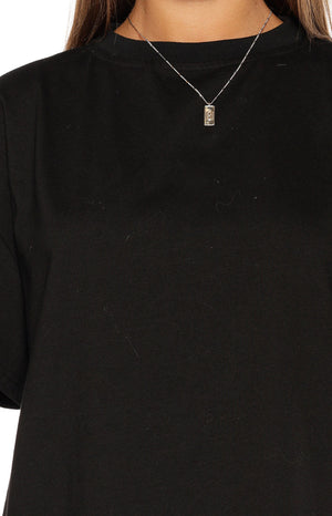 Close-up of the black crew neck tee showing the soft jersey knit fabric