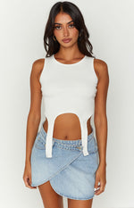 Light blue denim mini skirt featuring an asymmetrical wrap front and a single button closure