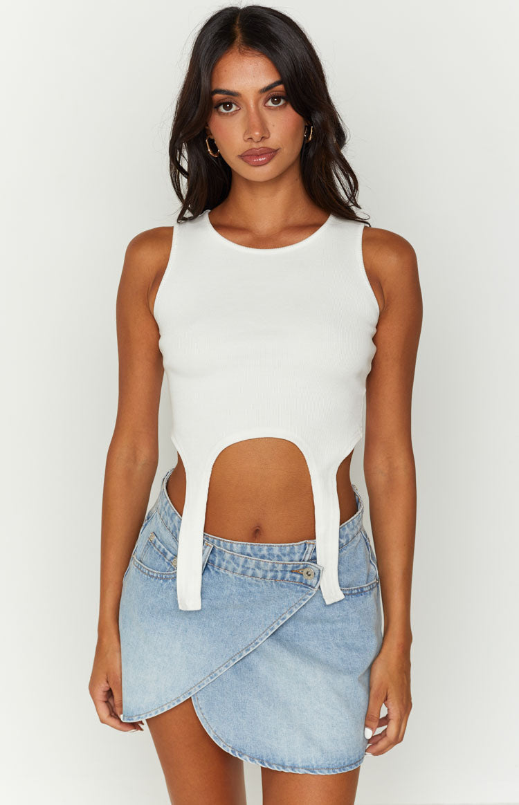 Light blue denim mini skirt featuring an asymmetrical wrap front and a single button closure