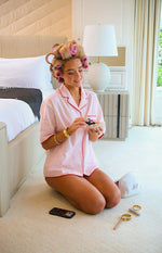 Pink stripe pajama shirt with red piping, notched collar, and short sleeves