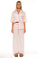 Model wears the Alexea Pink Stripe Pajama Pants a comfortable and elevated choice for sleepwear or lounging at home.