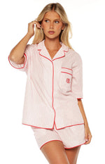 Pink and white striped pajama shirt with red piping on the collar, button-front, and cuffed sleeves, plus a chest pocket with an embroidered logo