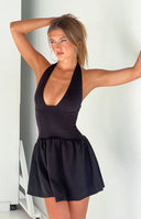 Black halter neck mini dress with deep V-neckline, structured bustier bodice, and gathered flippy skirt