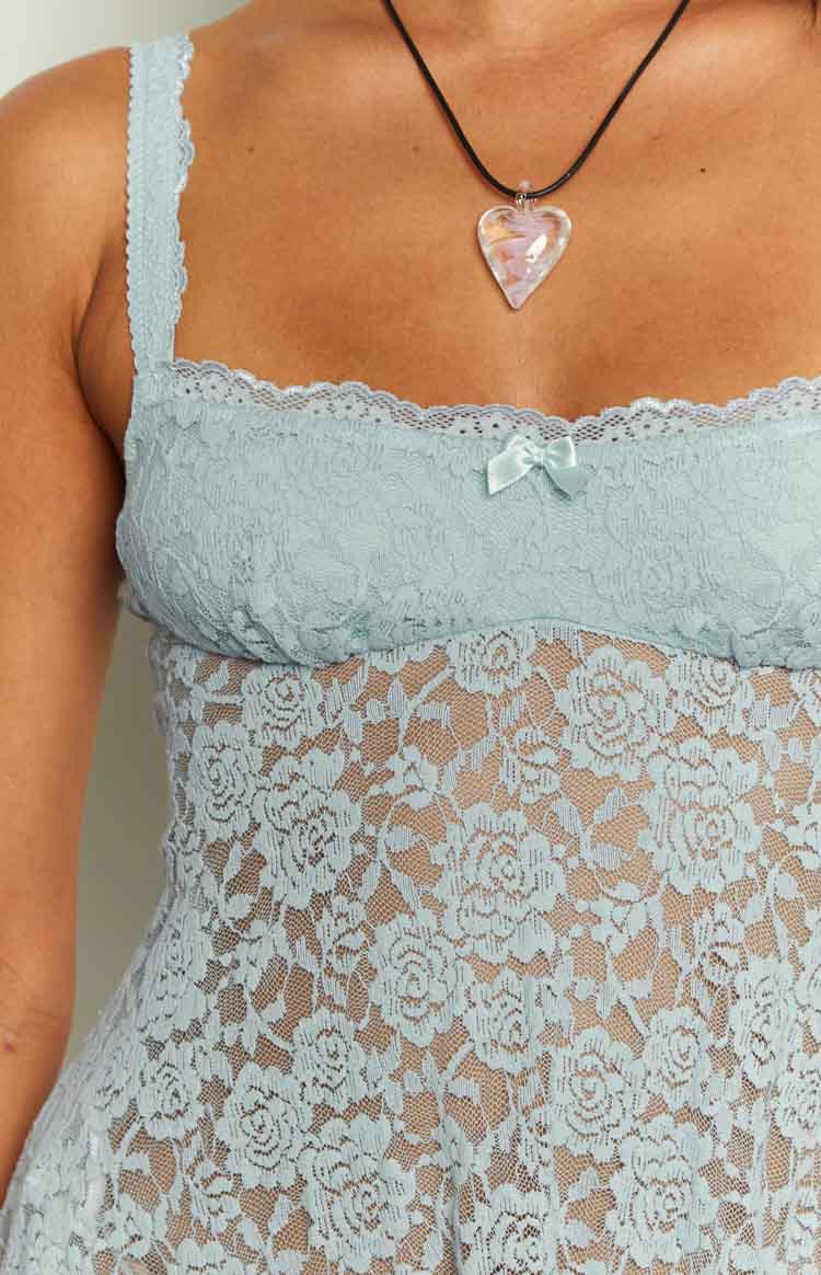 Close-up of the light blue floral lace mini dress with a square neckline, white scalloped trim, and small bow