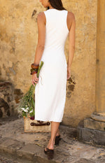Back view of a white sleeveless midi dress with a high rounded neckline and a fitted silhouette