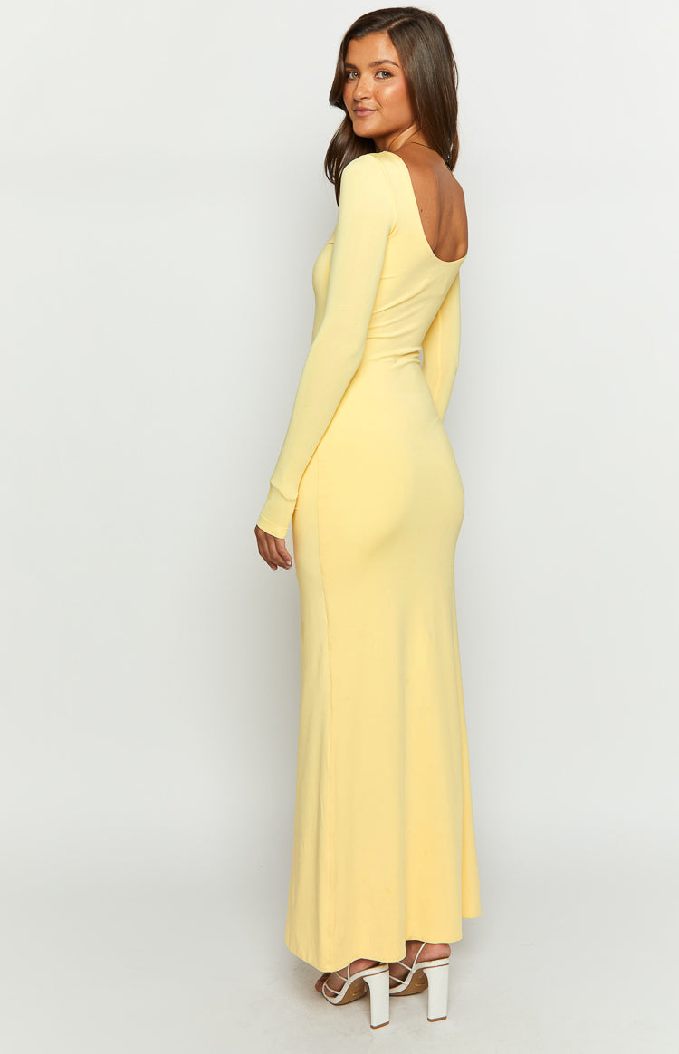 Side view of a yellow long sleeve maxi dress with a low scoop back and square neckline