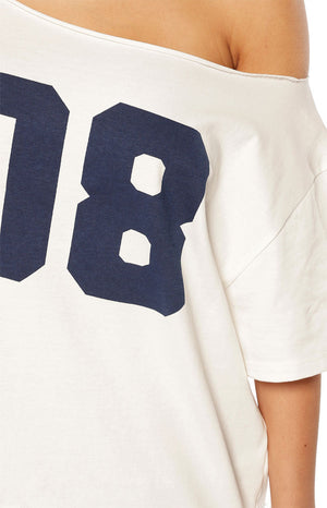 Stylish woman in a white off-shoulder 08 crop top and baggy jeans for a casual Spring brunch outfit