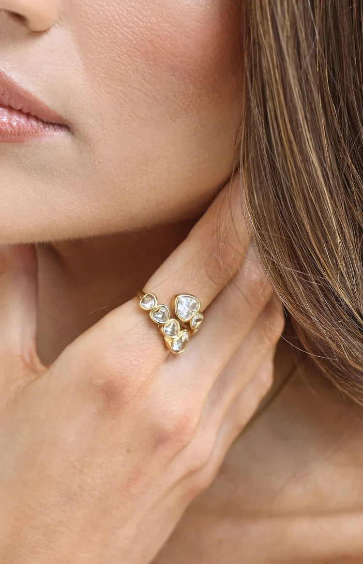 Close-up of the gold wrap ring with multiple heart-shaped diamantes