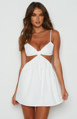 Front view of a white mini dress with a gathered sweetheart bust, thin spaghetti straps, and side waist cutouts