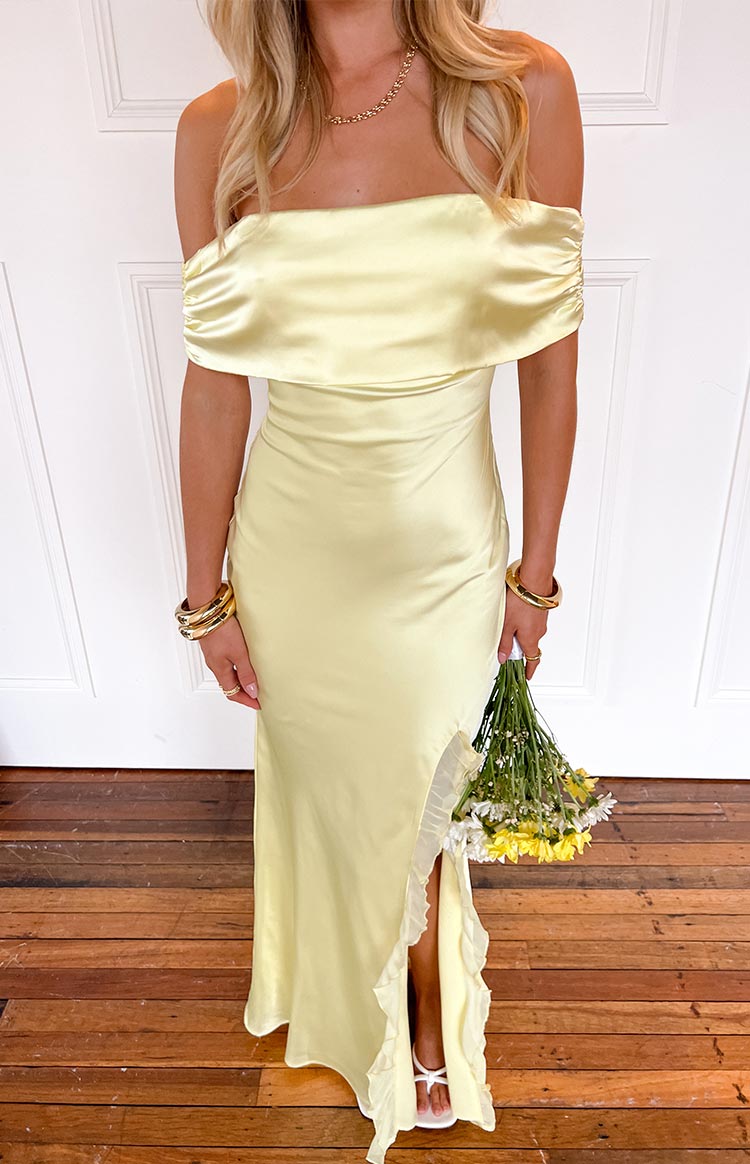 Yellow off-shoulder maxi dress with a gathered neckline and ruffled high side split
