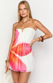 Front view of a white strapless mini dress with a gold O-ring bust detail and pink orange floral print