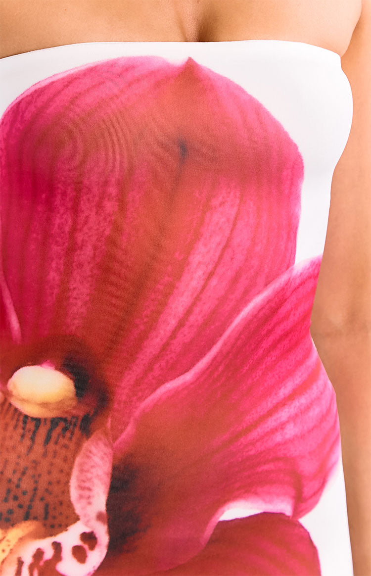 Full length view of the white strapless maxi dress with large red orchid print and ruched side detail
