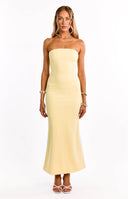 A model wears a bright yellow crepe maxi dress. This formal dress features a strapless straight neckline and a luxurious crepe fasbric. An elegant choice for a wedding guest or graduation dress.