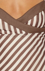 Detail of the brown and white diagonal stripe fabric and brown satin V-neck trim on the micro mini dress