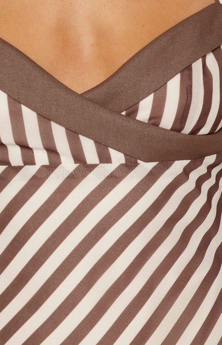 Detail of the brown and white diagonal stripe fabric and brown satin V-neck trim on the micro mini dress