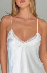 Close-up of the cream satin V-neckline with delicate lace trim and thin spaghetti straps