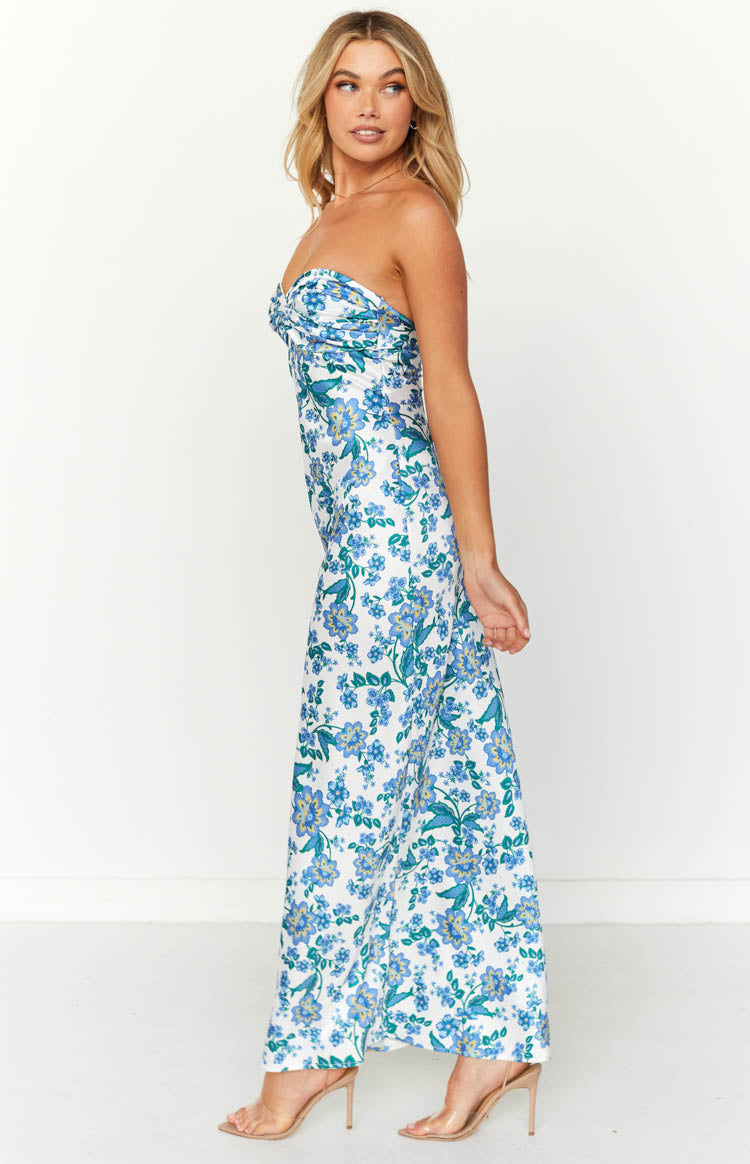 Side view of a white strapless maxi dress with blue floral print, showing the fitted bodice and full-length skirt