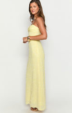 Side view of a yellow sequin strapless maxi dress with a ruched bust and fitted silhouette