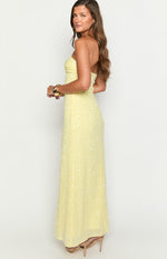 Side view of a yellow sequin strapless maxi dress with a ruched bust and fitted silhouette