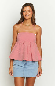 Front view of a red gingham halter top with a square neckline, white bow details, and a gathered peplum hem