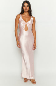 Front view of a light pink satin maxi dress with a twisted bust detail and a large oval cutout