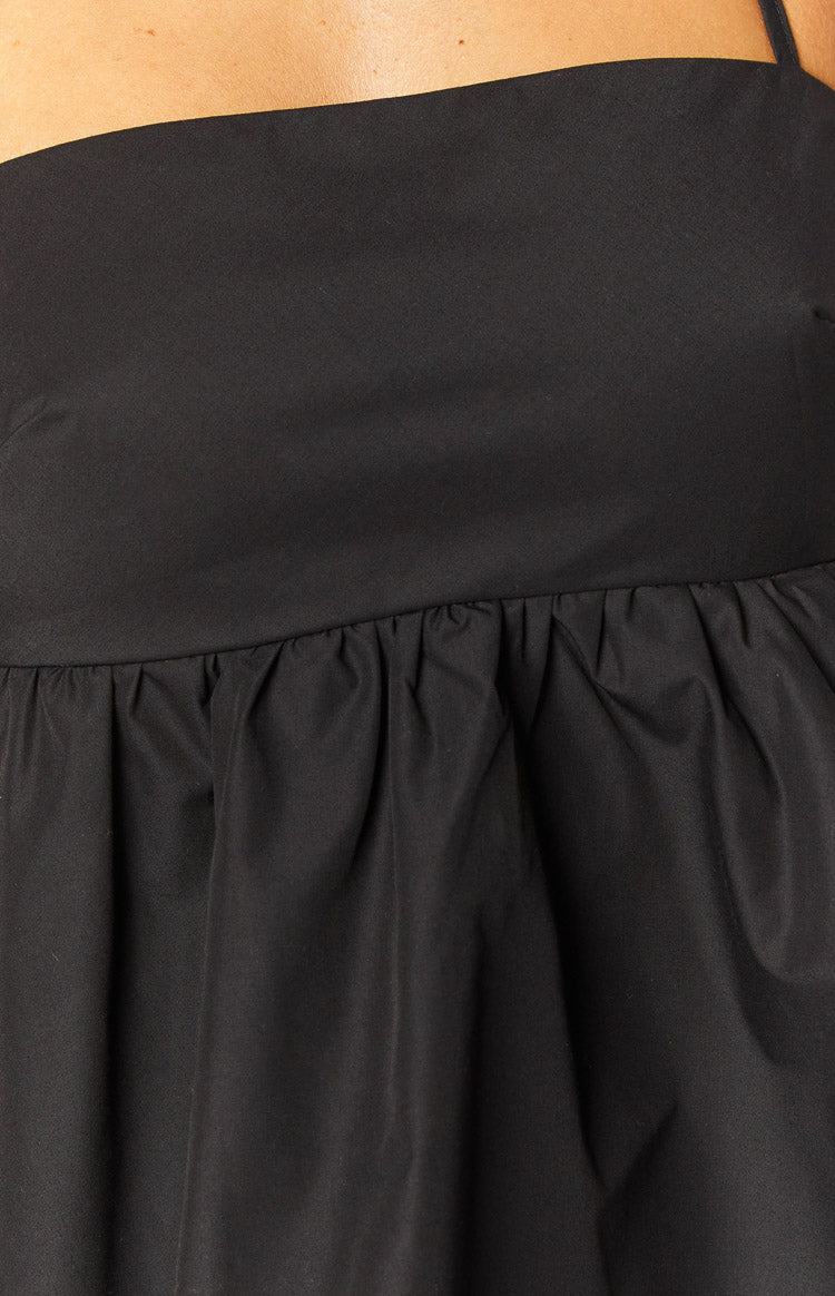 Close-up of the ruched detail on the black halter top
