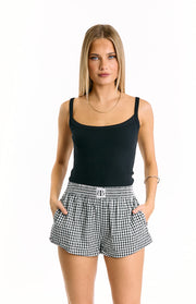 Front view of black gingham shorts with an elasticated ruched waistband and side pockets