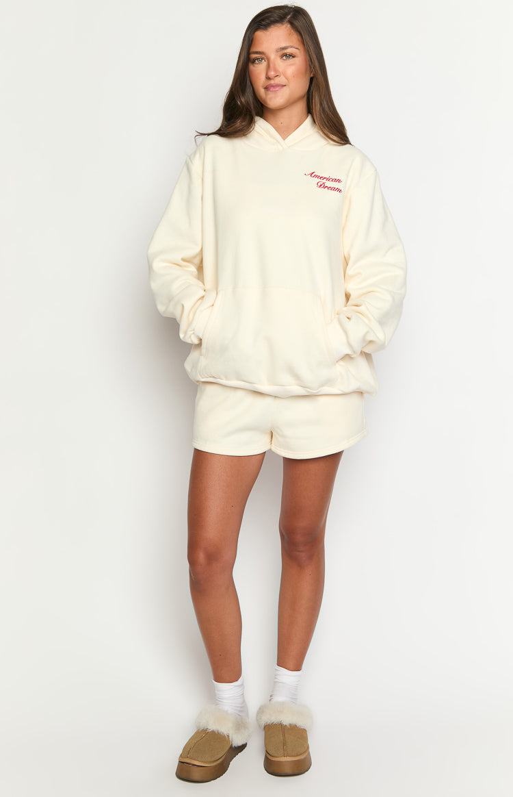 Cream oversized hoodie with red "American Dream" embroidery and a front kangaroo pocket