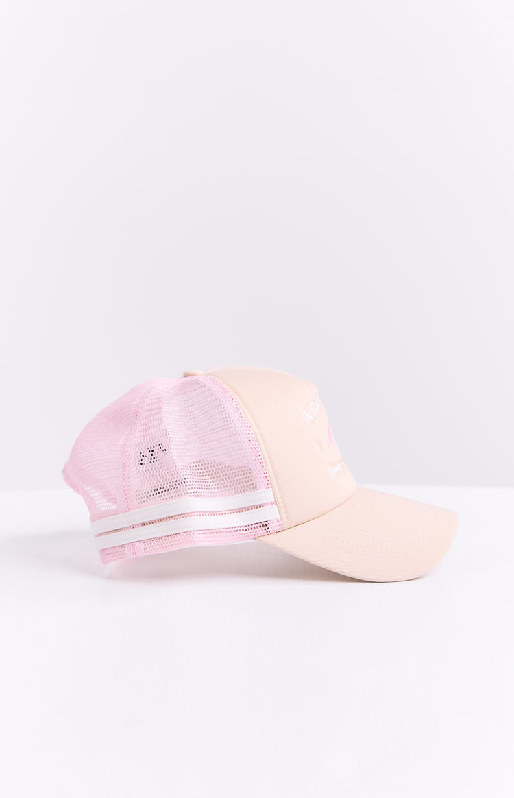 Side view of a cream trucker cap with a pink mesh back and two white stripes