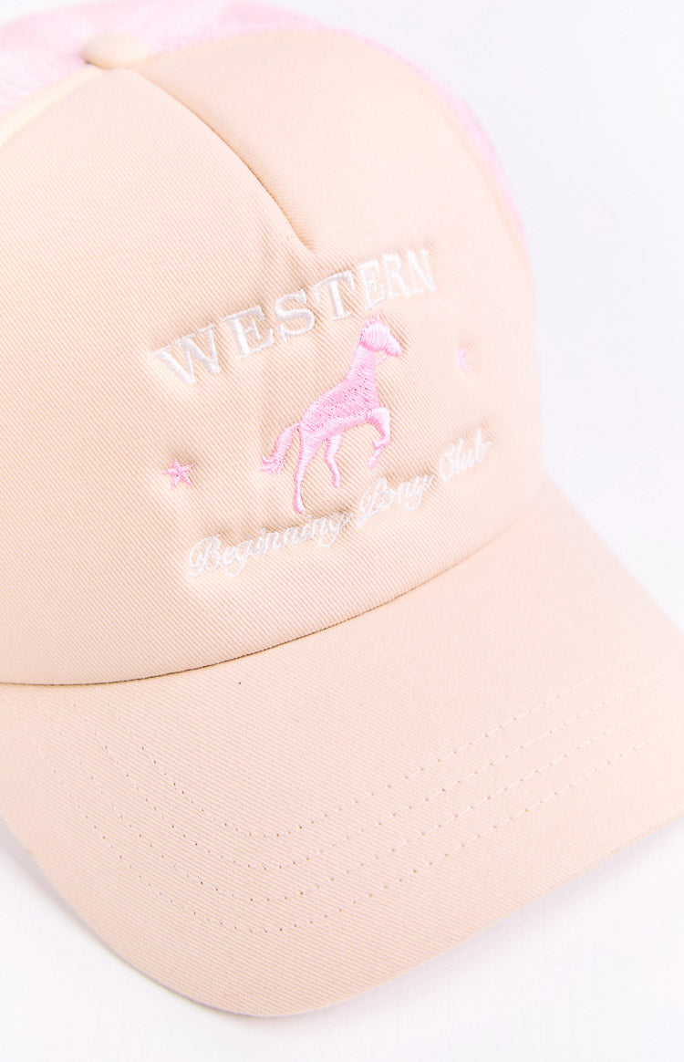 Close-up of the cream trucker cap's front panel and brim, with pink embroidered horse, white 'WESTERN' and 'Beginning Pony Club' text