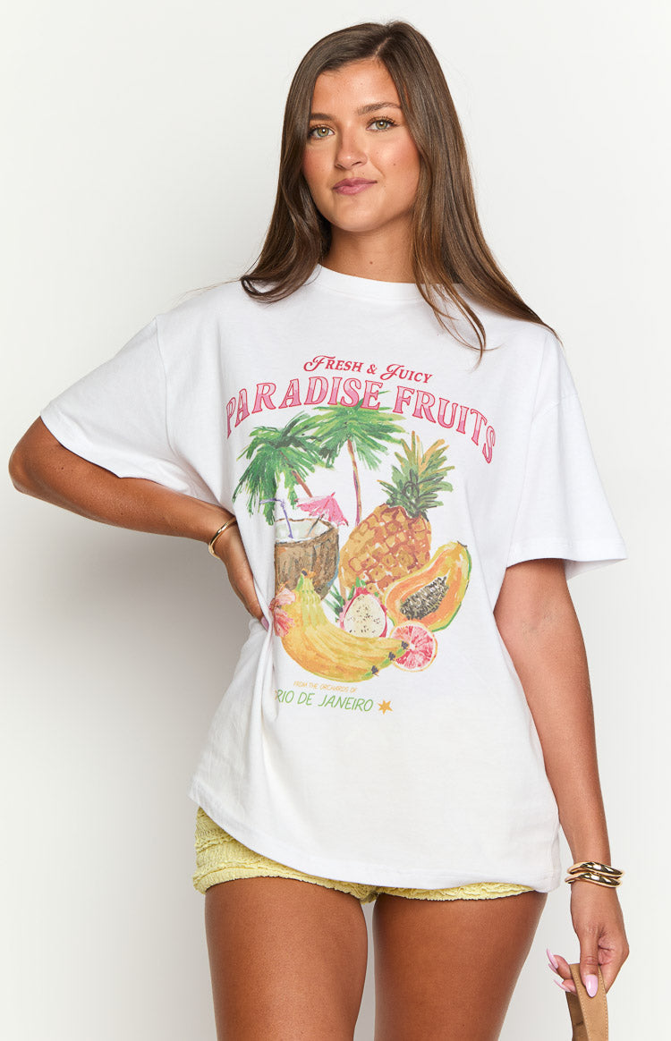White oversized tee with a large graphic print of tropical fruits including pineapple, papaya, banana, and palm trees