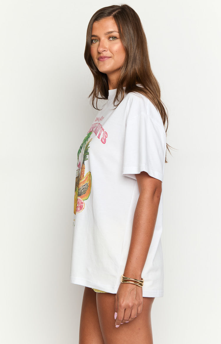 Side view of a white oversized tee with a colorful tropical fruit graphic print and relaxed short sleeves