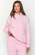 Front view of a pink hoodie showing the large kangaroo pocket with embroidered blue and pink stars