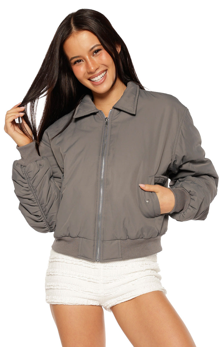 Grey bomber jacket with a collared neckline, full zip front, and ruched long sleeves