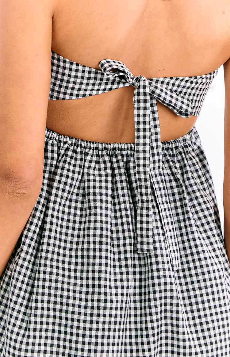 Close-up of the black gingham tie-back detail and cutout above the gathered elasticated waist