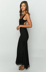 Side view of a black mesh maxi dress showing the ruched bust, side cutouts, and thin straps crossing at the back