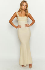 Front view of a cream mesh maxi dress with a square neckline, ruched bodice, and ribbed bodycon skirt