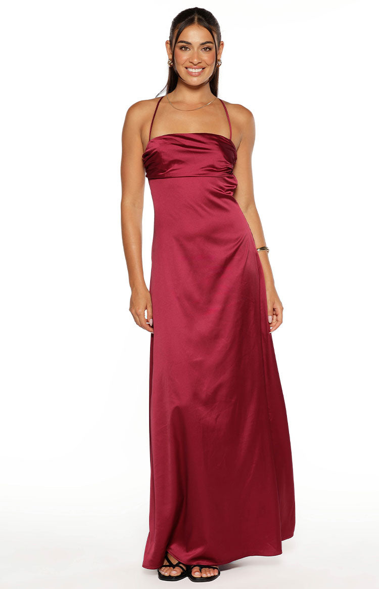 Full-length front view of a burgundy satin maxi dress featuring a halter neckline and ruched bodice