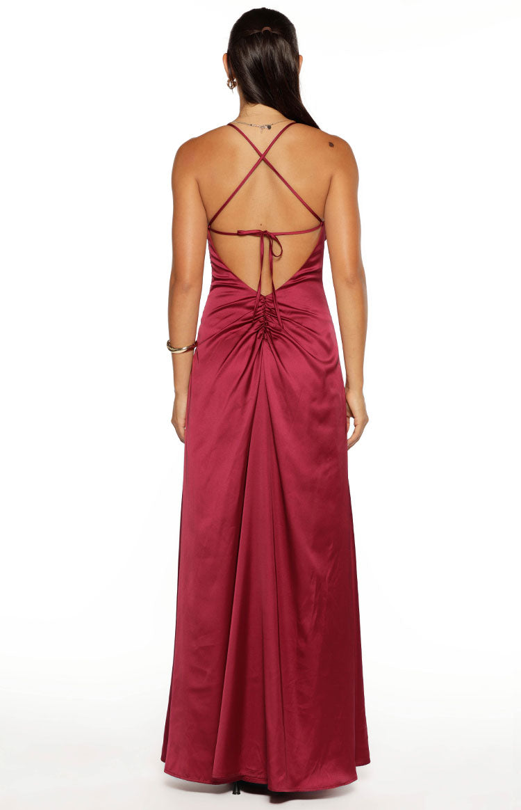 Rear view of the burgundy satin maxi dress with thin criss-cross back straps and a ruched tie detail