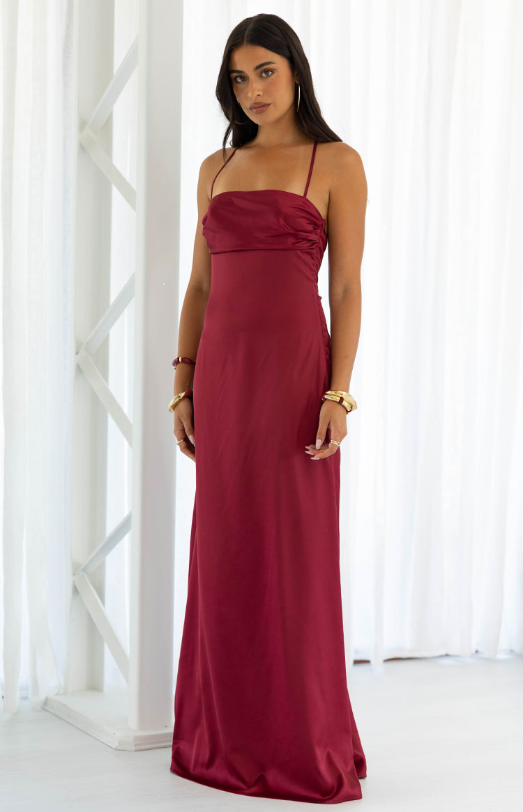 Ruched bust detail on a burgundy satin maxi dress with a straight neckline and thin spaghetti straps