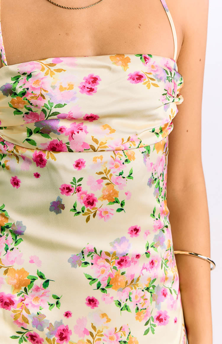 Close-up of the yellow satin floral print with pink and orange blooms and ruched bust detail